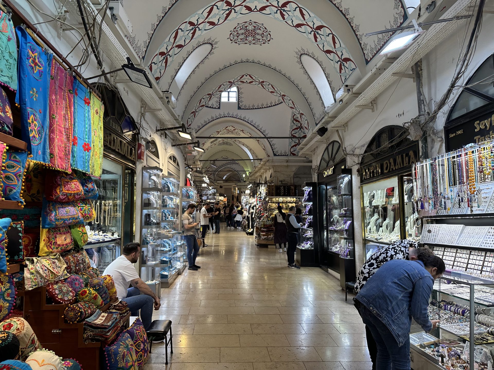 Colorful cushions and textiles lining a Grand Bazaar corridor in Istanbul