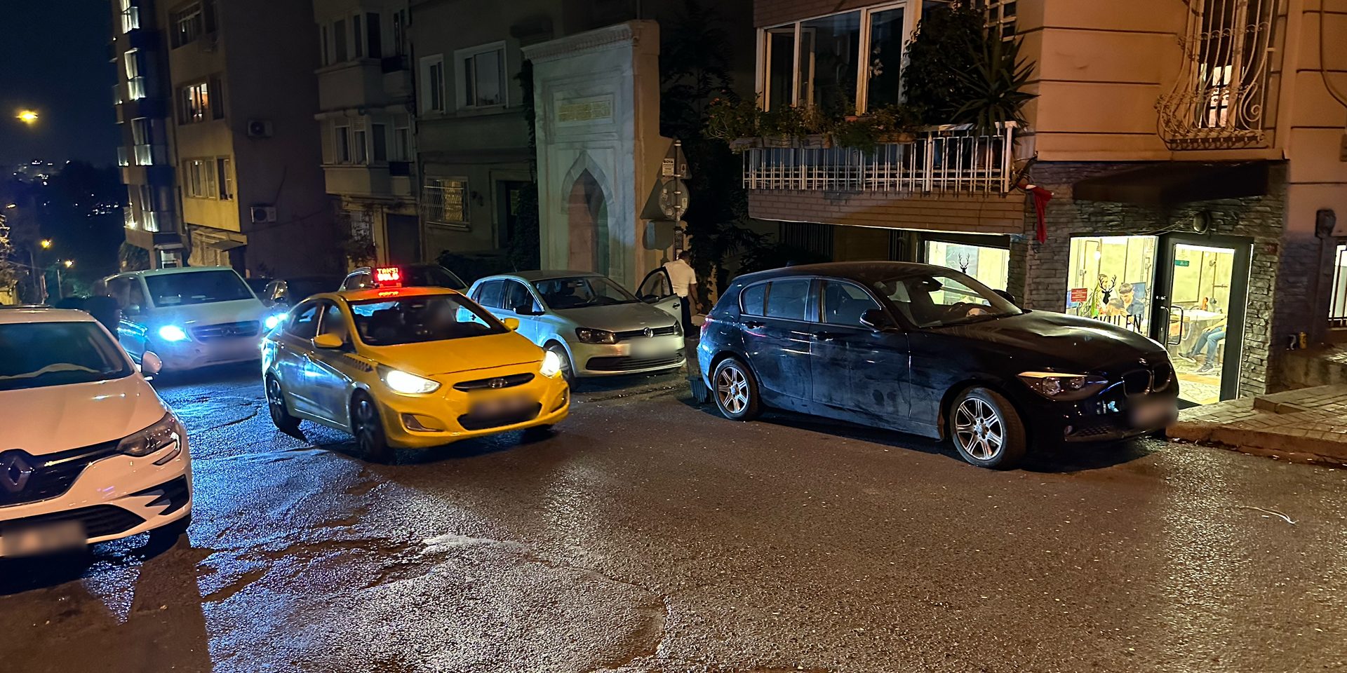 At night, a yellow Istanbul taxi with a red light, meaning it's full.