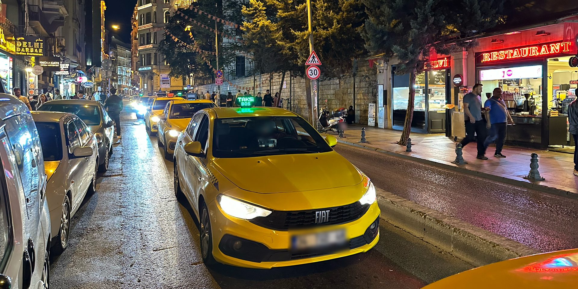 A line of taxis in Istanbul at night.