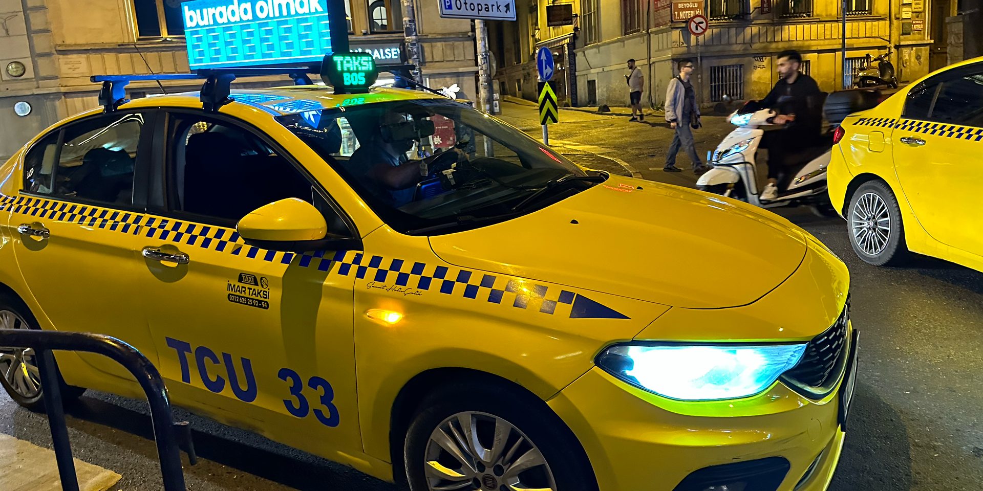 At night, a yellow Istanbul taxi with a lit “TAKSİ BOŞ” sign, meaning it's free and ready for new customers.