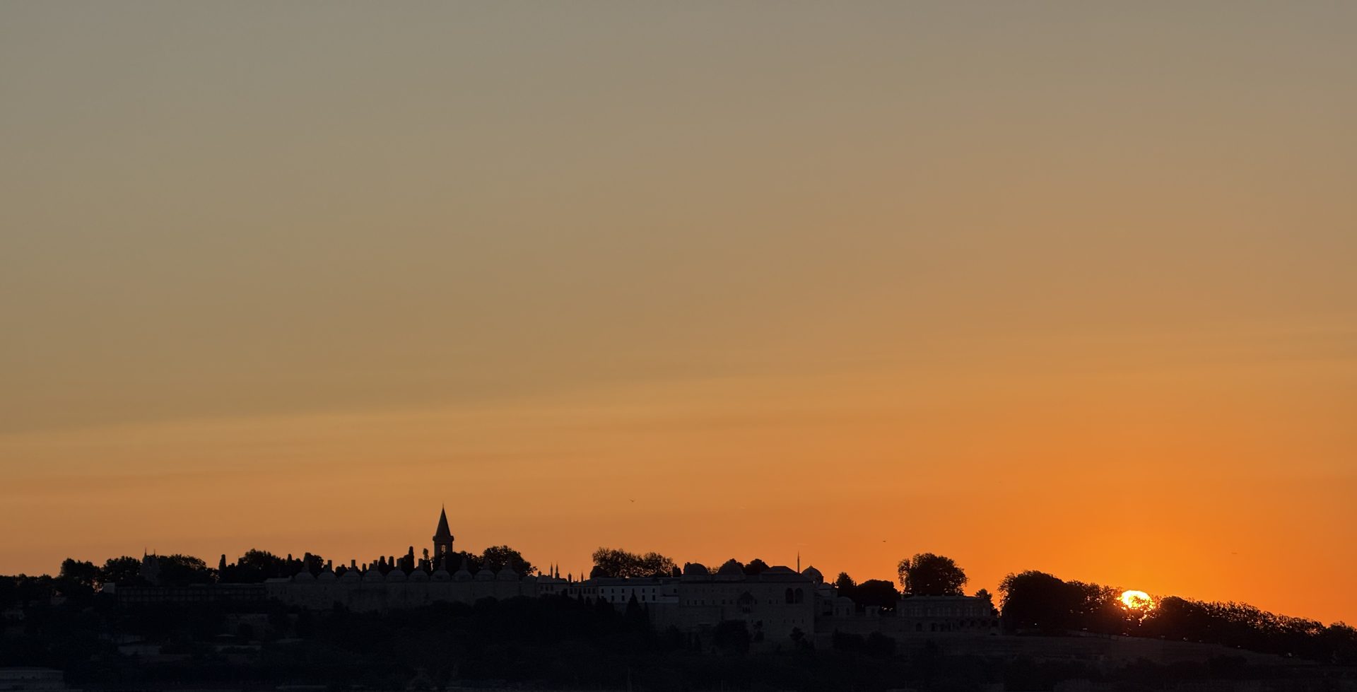 Topkapi Palace skyline silhouetted at sunset across the Bosphorus, Istanbul